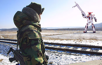 Above: A South Korean border soldier eyes Kim Jong Il in the Demilitarized Zone.